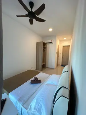 a bedroom with a bed with a ceiling fan at KLCC Kampung Baru Cottage - Homestay in Kuala Lumpur