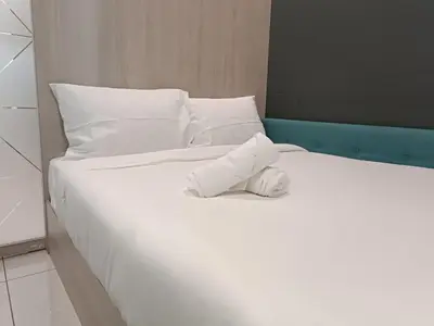 a white bed with a stuffed animal on it at S36- Robertson at Bukit Bintang 3 Bedroom with Netflix in Kuala Lumpur