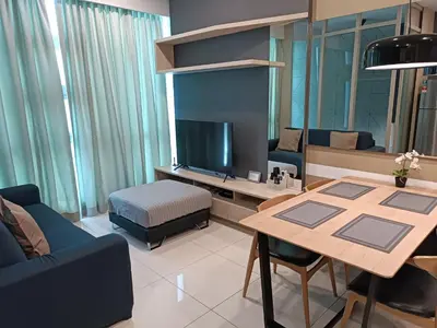 a living room with a table and a tv at S37- Bukit Bintang 3 Bedroom Suite with Netflix Robertson in Kuala Lumpur
