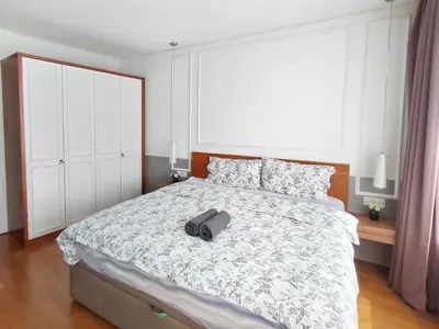 a bedroom with a bed with a pair of shoes on it at Luxury 2BR Home in Vortex Stunning KL Tower View Free WiFi in Kuala Lumpur