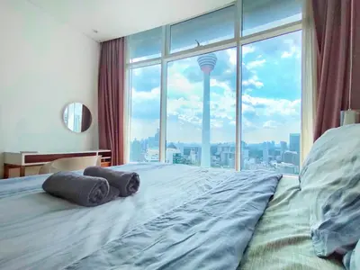 a bedroom with a large bed with a large window at Luxury 2BR Home in Vortex Stunning KL Tower View Free WiFi in Kuala Lumpur