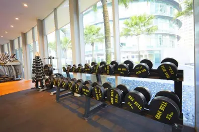 a room with a bunch of dumbbells in a gym at Luxury 2BR Home in Vortex Stunning KL Tower View Free WiFi in Kuala Lumpur