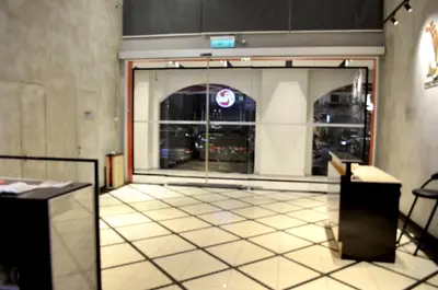 an open door to a store with a tile floor at RED ROOM Kuala Lumpur in Kuala Lumpur