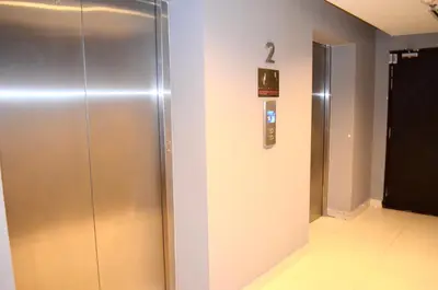 a metal elevator in a building with a sign on the wall at RED ROOM Kuala Lumpur in Kuala Lumpur