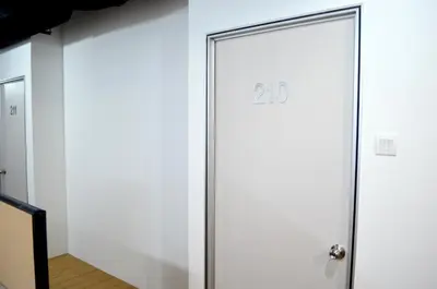 a white door with the number on it at RED ROOM Kuala Lumpur in Kuala Lumpur
