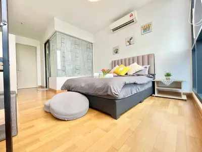 a bedroom with a bed and a wooden floor at KL Gateway 2B2B Cozy apartment in Kuala Lumpur