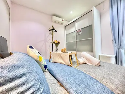a bedroom with two beds and a window at KL Gateway 2B2B Cozy apartment in Kuala Lumpur