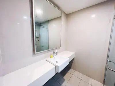 a white bathroom with a sink and a mirror at PROMO CONNECTED TRAIN 1 Bedroom ABOVE MALL - 5 in Kuala Lumpur