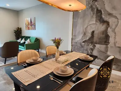 a dining room with a black table and chairs at The Platinum 2 by MiuKy KLCC, Kuala Lumpur in Kuala Lumpur