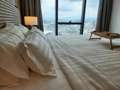 a bed in a hotel room with a large window at The Platinum 2 by MiuKy KLCC, Kuala Lumpur in Kuala Lumpur
