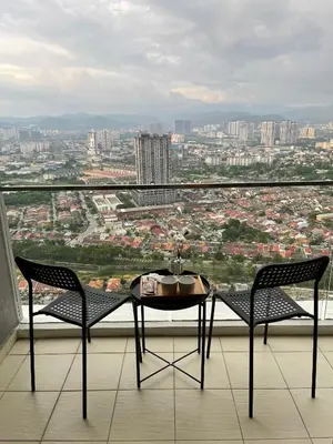 a table and two chairs on a balcony with a view at 7PAX Kepong DesaPark Publika MontKiara 100Mbps in Kuala Lumpur