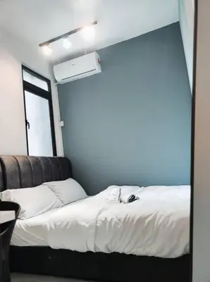 a bedroom with a white bed with a window at Neu suites 007- 2 bedrooms klcc in Kuala Lumpur