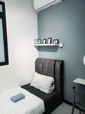 a room with a bed with a pillow and a shelf at Neu suites 007- 2 bedrooms klcc in Kuala Lumpur