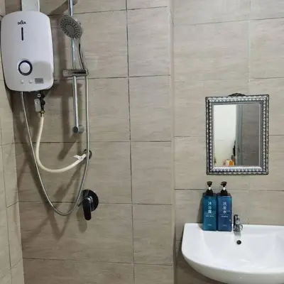 a bathroom with a shower and a sink and a mirror at Titiwangsa 6PX near monorail PWTC Infinity pool in Kuala Lumpur