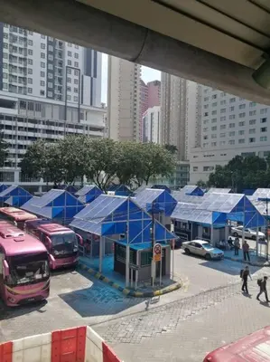 a group of blue tents in a parking lot with cars at Titiwangsa 6PX near monorail PWTC Infinity pool in Kuala Lumpur