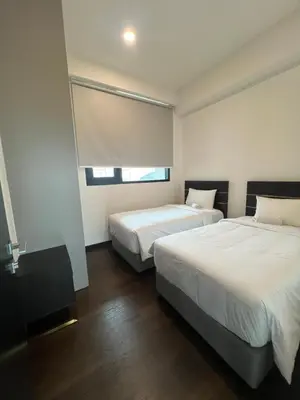 a bedroom with two beds and a window at Opus Residences KL Merdeka 118 View in Kuala Lumpur