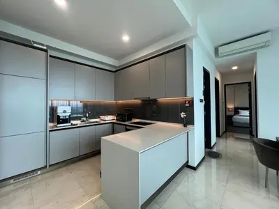 a kitchen with white cabinets and a white counter top at Opus Residences KL Merdeka 118 View in Kuala Lumpur