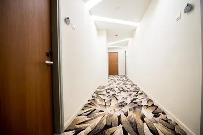 a hallway with a stairwell with a floor covered in wood at Chill Suites Kuala Lumpur in Kuala Lumpur