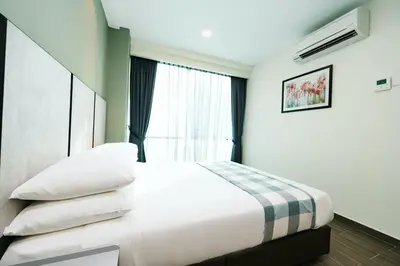 a bedroom with a bed and a window at Chill Suites Kuala Lumpur in Kuala Lumpur