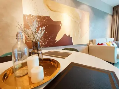 a room with a table with a glass bottle and candles at Stylish KL Suite, KLCC View, Next to LRT, Datum Jelatek By Atlantis Management in Kuala Lumpur