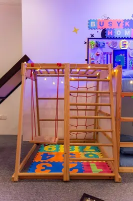 a bunk bed with a swing in a room at Kuala Lumpur Kids Friendly Playground Bunk Bed in Kuala Lumpur