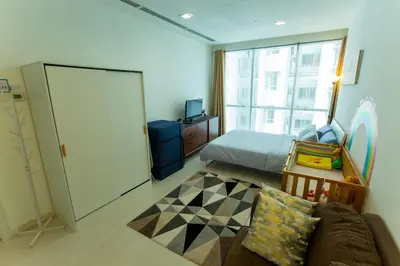 a bedroom with a bed and a couch and a window at Kuala Lumpur Kids Friendly Playground Bunk Bed in Kuala Lumpur