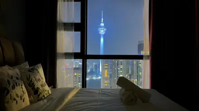 a bedroom with a bed with a view of a city at Skyline view in Bukit Bintang The Robertson 42f in Kuala Lumpur