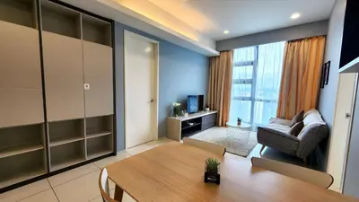a living room with a table and a chair at Skyline view in Bukit Bintang The Robertson 42f in Kuala Lumpur