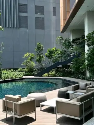 a swimming pool with lounge chairs and a building at Lucentia Residence By Home Horizon in Kuala Lumpur