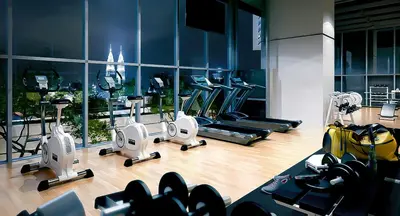 a gym with several treadmills and machines in it at Lucentia Residence By Home Horizon in Kuala Lumpur