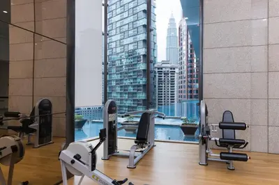 a gym with a view of a city skyline at Bukit Bintang Signatures Pavilion Kuala Lumpur in Kuala Lumpur