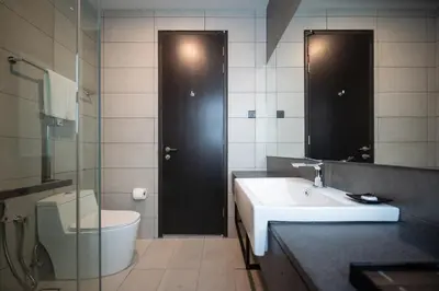 a bathroom with a sink and a toilet and a mirror at Opus KL Residences by Premium Hospitality in Kuala Lumpur