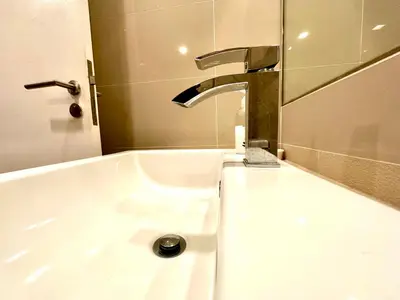 a sink with a faucet in a bathroom at Roomy Suites @One Bukit Ceylon in Kuala Lumpur