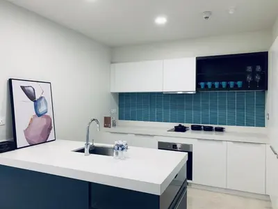 a kitchen with white cabinets and a sink at Tropicana The Residences KLCC, Premium in Kuala Lumpur