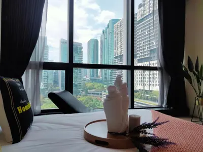 a hotel room with a view of a city from a window at Bangsar Trade Center Studio 4pax I HomeBrickz in Kuala Lumpur