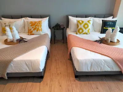a room with two twin beds with pillows at Bangsar Trade Center Studio 4pax I HomeBrickz in Kuala Lumpur