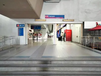 an empty hallway of a subway station with stairs at Bangsar Trade Center Studio 4pax I HomeBrickz in Kuala Lumpur