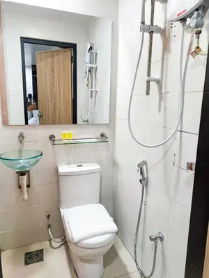 a bathroom with a toilet and a shower at Red Velvet Inn Bukit Bintang in Kuala Lumpur