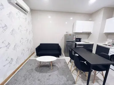 a small kitchen with a black table and chairs at [PROMO]Connected train 1 Bedroom (ABOVE MALL)6 in Kuala Lumpur