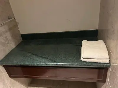 a green counter in a bathroom with a towel at KSM GLOBAL APARTMENT At TIMES SQUARE kl in Kuala Lumpur