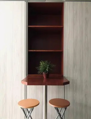 a shelf with two stools and a plant on it at Duplex Axis Condo @Ampang nearby KLCC. in Ampang