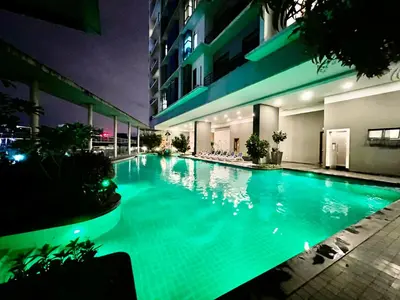 a large swimming pool in a building at night at Casa Residency Service Apartment in Kuala Lumpur