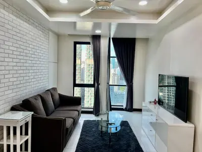 a living room with a couch and a tv at Casa Residency Service Apartment in Kuala Lumpur