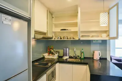 a kitchen with a sink and a refrigerator at Casa Residency Service Apartment in Kuala Lumpur