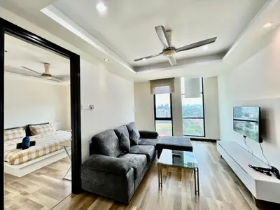 a living room with a couch and a mirror at Casa Residency Service Apartment in Kuala Lumpur
