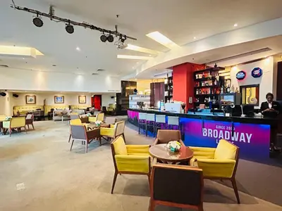 a restaurant with a bar with chairs and tables and a lobby at PERFECT HOME STAY at TIMES SQUARE in Kuala Lumpur