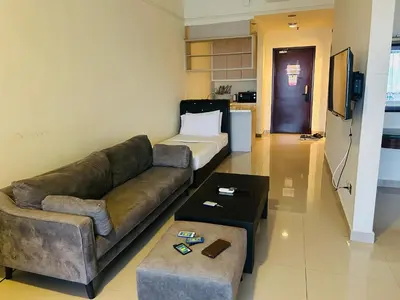 a living room with a couch and a bed at PERFECT HOME STAY at TIMES SQUARE in Kuala Lumpur