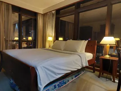 a bedroom with a large bed with a large window at PERFECT HOME STAY at TIMES SQUARE in Kuala Lumpur