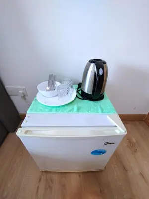 a tea kettle is sitting on top of a refrigerator at The Colony KLCC view by NZV in Kuala Lumpur