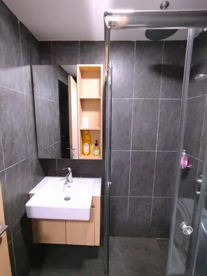 a bathroom with a sink and a shower at The Colony KLCC view by NZV in Kuala Lumpur